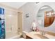This bathroom offers a combination tub and shower with updated faucet and vanity with attractive round mirror at 4590 Turkey Track Rd, Martinsville, IN 46151