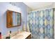 Standard bathroom with a single sink vanity with cabinet and a shower with blue diamond pattern shower curtain at 4590 Turkey Track Rd, Martinsville, IN 46151