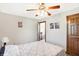 Bedroom with a ceiling fan, a window, and a bed; the image shows an open door leading out of the room at 4590 Turkey Track Rd, Martinsville, IN 46151