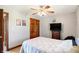 Neutrally decorated bedroom featuring a ceiling fan, double door closet, and a television on a dresser at 4590 Turkey Track Rd, Martinsville, IN 46151