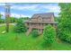 Aerial view of a home featuring a wrap-around porch and nestled in a green landscape at 4590 Turkey Track Rd, Martinsville, IN 46151