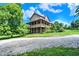 Home exterior with a covered porch and lots of large, mature trees at 4590 Turkey Track Rd, Martinsville, IN 46151