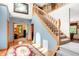 Grand foyer showcases a beautiful staircase, hardwood floors, and natural light at 4590 Turkey Track Rd, Martinsville, IN 46151