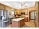 Bright kitchen with stainless steel appliances, center island, and wood cabinetry at 4590 Turkey Track Rd, Martinsville, IN 46151