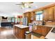 Open-concept kitchen with stainless steel appliances and island flows seamlessly into the dining area and living room at 4590 Turkey Track Rd, Martinsville, IN 46151