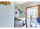 Bright laundry room with modern washer and dryer, storage shelves, and access to the outdoors at 4590 Turkey Track Rd, Martinsville, IN 46151