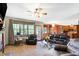 Bright living room with a fireplace, a ceiling fan, and access to the backyard at 4590 Turkey Track Rd, Martinsville, IN 46151