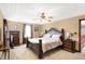 Bedroom boasts a tray ceiling, ceiling fan, and dresser, creating a comfortable and stylish retreat at 4590 Turkey Track Rd, Martinsville, IN 46151