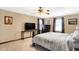 Spacious main bedroom features a ceiling fan, TV, and neutral carpet at 4590 Turkey Track Rd, Martinsville, IN 46151