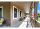 Long, covered porch with seating, perfect for outdoor relaxation and enjoyment at 4590 Turkey Track Rd, Martinsville, IN 46151