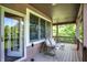 Comfortable covered porch featuring a porch swing and recessed lighting for relaxation at 4590 Turkey Track Rd, Martinsville, IN 46151