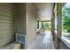 Long, covered porch with a swing, perfect for enjoying the outdoors at 4590 Turkey Track Rd, Martinsville, IN 46151