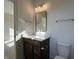 Bathroom vanity with wood cabinets, white countertop, and chrome faucet paired with a matching framed mirror at 477 Mariposa Trl, Carmel, IN 46032