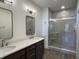 Bathroom featuring double sinks with stylish vanity and a glass enclosed walk in shower at 477 Mariposa Trl, Carmel, IN 46032