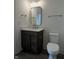 Modern bathroom featuring a vanity with dark wood cabinets and a white countertop, plus a toilet and chrome fixtures at 477 Mariposa Trl, Carmel, IN 46032