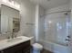 Bathroom with a modern vanity, toilet, and combined bathtub-shower with bright lighting and white tile surround at 477 Mariposa Trl, Carmel, IN 46032