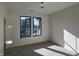 Bright bedroom with carpet floors, large windows offering neighborhood views, and a modern lighting fixture at 477 Mariposa Trl, Carmel, IN 46032