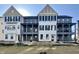 Beautiful townhome exterior featuring modern architectural details, neutral colors, and covered patios at 477 Mariposa Trl, Carmel, IN 46032