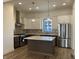 Bright kitchen with stainless steel appliances, granite countertops, and large central island at 477 Mariposa Trl, Carmel, IN 46032