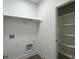 Functional laundry room with storage shelf, washer and dryer hookups at 477 Mariposa Trl, Carmel, IN 46032