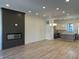 Open-concept living area showcasing a modern fireplace, recessed lighting, and access to kitchen at 477 Mariposa Trl, Carmel, IN 46032