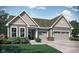 Charming single-story home features a gray exterior, attached garage, and well-manicured lawn and decorative landscaping at 5052 Astor Ct, McCordsville, IN 46055