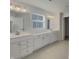 Bright bathroom featuring double sinks, white cabinetry, and modern fixtures at 649 Washington St, Fortville, IN 46040