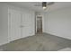 Neutral bedroom features carpet, ceiling fan, and closet with bi-fold doors at 649 Washington St, Fortville, IN 46040