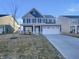 Charming two-story home featuring blue siding, stone accents, and a spacious two-car garage at 649 Washington St, Fortville, IN 46040