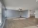 Spacious living room with hardwood floors, ample natural light, and a ceiling fan at 649 Washington St, Fortville, IN 46040