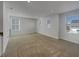 Bright living area with multiple windows and soft carpeting at 649 Washington St, Fortville, IN 46040