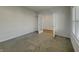 Spacious living room with carpet and open doorway to another room in neutral colors at 649 Washington St, Fortville, IN 46040