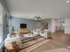Bright living room with stylish furniture, hardwood floors, and a ceiling fan at 649 Washington St, Fortville, IN 46040