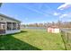 Expansive backyard with screened porch, grassy lawn, storage shed, and scenic waterfront view at 6843 Long Run Dr, Indianapolis, IN 46268
