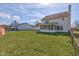Expansive backyard featuring lush lawn, privacy fence, and charming screened porch at 6843 Long Run Dr, Indianapolis, IN 46268