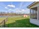 Beautiful backyard featuring a manicured lawn, shed, waterfront view, and screened porch at 6843 Long Run Dr, Indianapolis, IN 46268