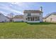 Large backyard with lush green grass, screened porch, and fenced perimeter at 6843 Long Run Dr, Indianapolis, IN 46268