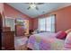 Bedroom with a large bed, wooden furniture and a ceiling fan at 6843 Long Run Dr, Indianapolis, IN 46268