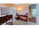 A bedroom displays a desk with a computer, a dresser, and a doorway to another room at 6843 Long Run Dr, Indianapolis, IN 46268