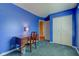 Bedroom featuring bright blue walls, a built-in closet, and a well-lit window at 6843 Long Run Dr, Indianapolis, IN 46268