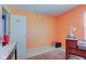 Bedroom with brightly painted walls, a desk, and a window offering plenty of natural light at 6843 Long Run Dr, Indianapolis, IN 46268