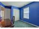 Bedroom showcasing its bright blue walls, built-in closet, and a well-lit window at 6843 Long Run Dr, Indianapolis, IN 46268