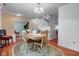 An inviting dining area features a round table, complemented by hardwood floors and a staircase in view at 6843 Long Run Dr, Indianapolis, IN 46268