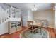 Traditional dining room with hardwood floors, a round table, and a staircase visible, radiates warmth at 6843 Long Run Dr, Indianapolis, IN 46268