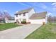 Charming two-story home with an attached garage and a long driveway at 6843 Long Run Dr, Indianapolis, IN 46268