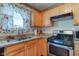 Functional kitchen featuring granite countertops, stainless steel appliances, and charming strawberry-themed accents at 6843 Long Run Dr, Indianapolis, IN 46268