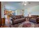 Spacious living room featuring a comfortable sofa, a cozy armchair, and a view into the adjacent kitchen area at 6843 Long Run Dr, Indianapolis, IN 46268