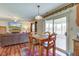 Inviting space with kitchen view, dining table set, and large TV showcasing the home's exterior over the fireplace at 6843 Long Run Dr, Indianapolis, IN 46268