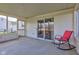 Screened porch featuring neutral walls and concrete floor with rocking chair near sliding door at 6843 Long Run Dr, Indianapolis, IN 46268