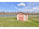 A charming outdoor shed with a red trim, offering practical storage solutions at 6843 Long Run Dr, Indianapolis, IN 46268